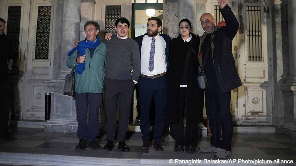 Rescue volunteers and their lawyer pose outside a courthouse in Mytilene, on the northeastern Aegean island of Lesbos, Greece, Thursday, Jan. 15, 2026, after being acquitted of charges related to aiding migrants. (AP Photo/Panagiotis Balaskas)