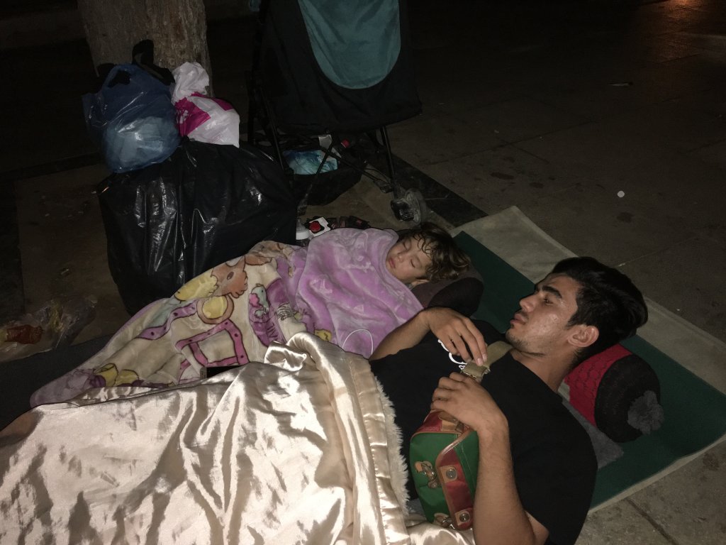 From file: A young Afghan man and his son sleep on the ground in Victoria Square, Athens | Photo: Marion MacGregor/InfoMigrants