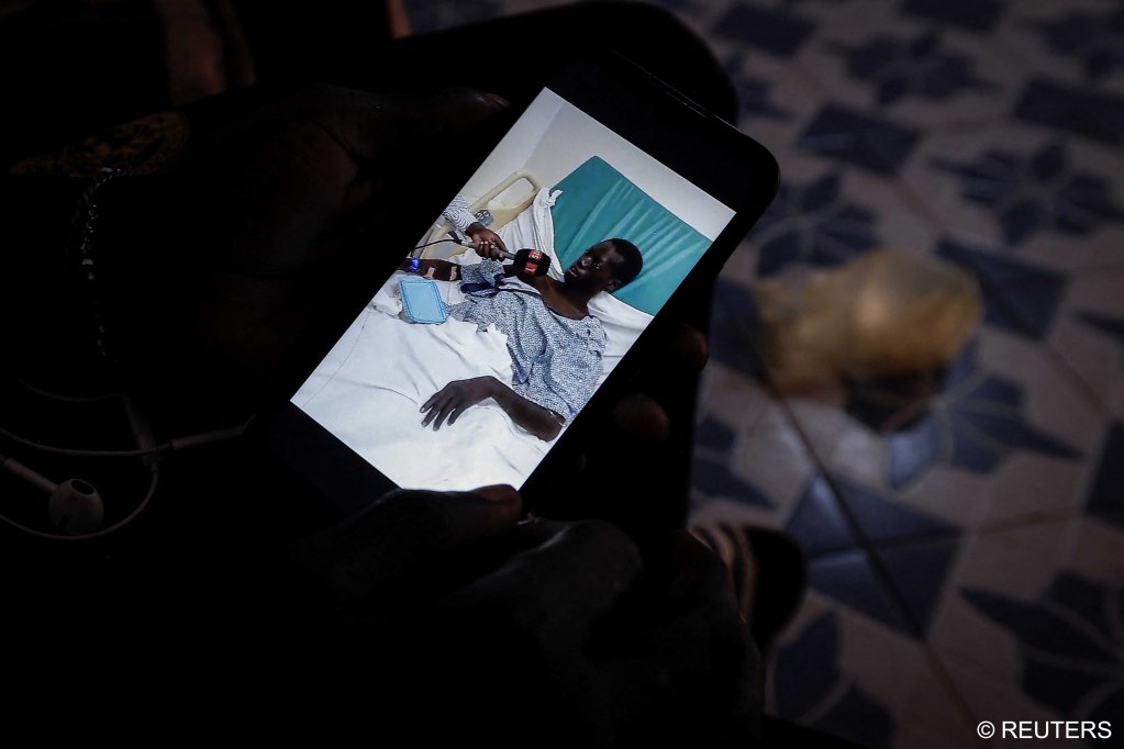 Fisherman Aline Dieye, 21, one of the survivors of last year's shipwreck, shows a photograph on his mobile phone from his hospitalization after being rescued at sea, during an interview at his house in Fass Boye, Senegal, February 1, 2024.  | Photo: REUTERS/Zohra Bensemra