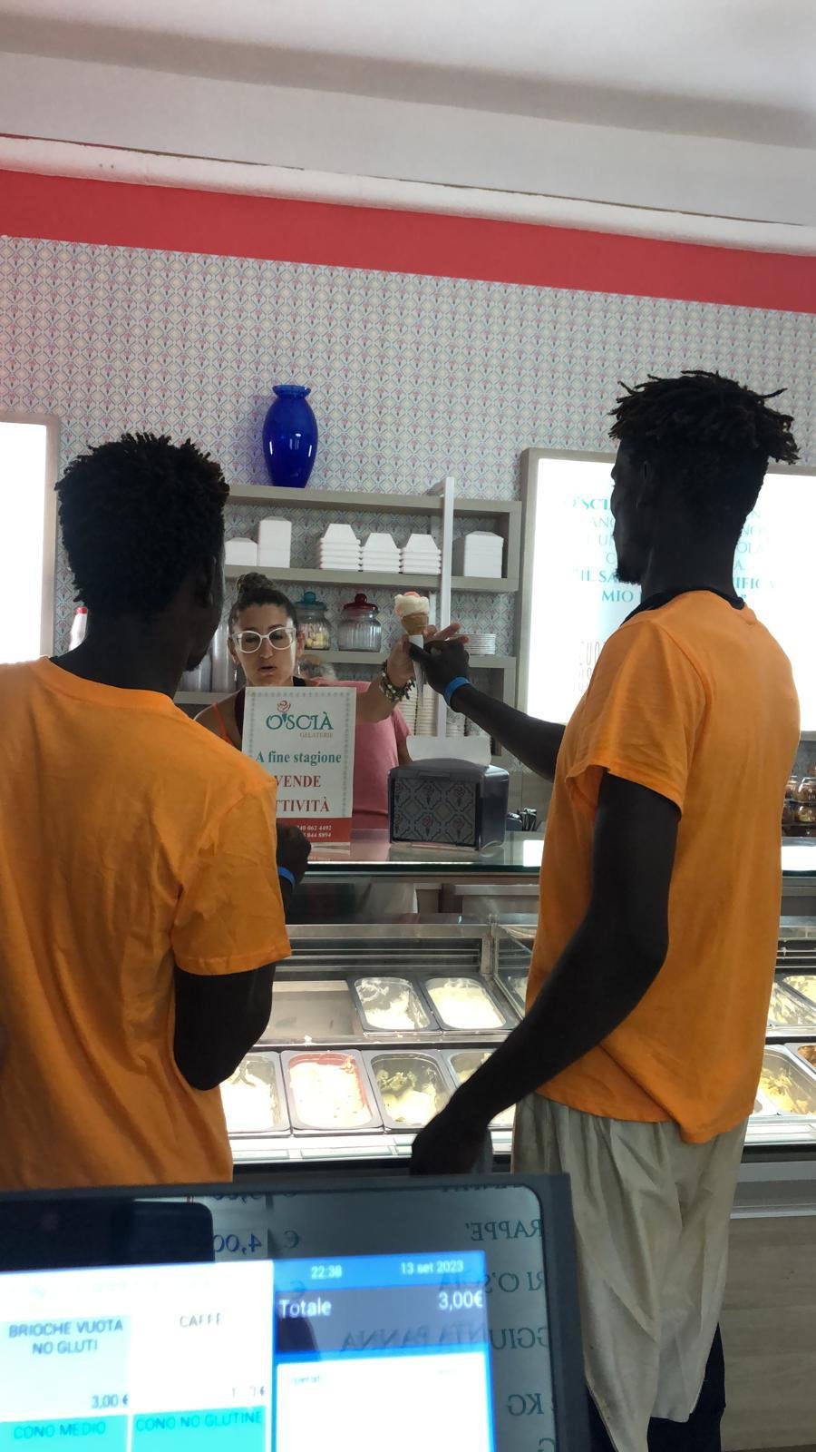 Two young migrants benefit from free ice cream at the O'Scia gelateria on Lampedusa| Photo: Private