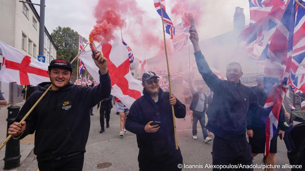 Supporters of the far-right Britain First party wave Union Flags and St George' s flags during an anti-immigration rally in Tamworth, United Kingdom, on September 12, 2026 | Photo: Joannis Alexopoulos/Anadolu