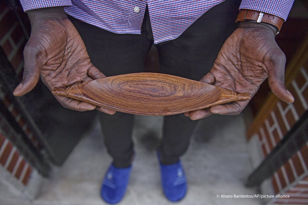 Mbaye Babacar Diouf, 33, holds a small wooden boat as a reminder of the boats migrants travel in, at his home in the basque city of Algorta, northern Spain | Photo: Alvaro Barrientos / AP Photo / picture-alliance