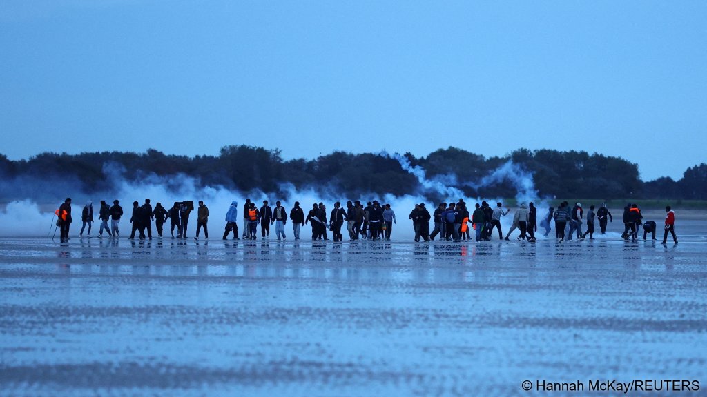 At another beach near Calais, this time Petit-Fort-Philippe near Gravelines, migrants react to tear gas fired by the police as they attempt to board a boat on September 28, 2026 | Photo: Hannah McKay / Reuters