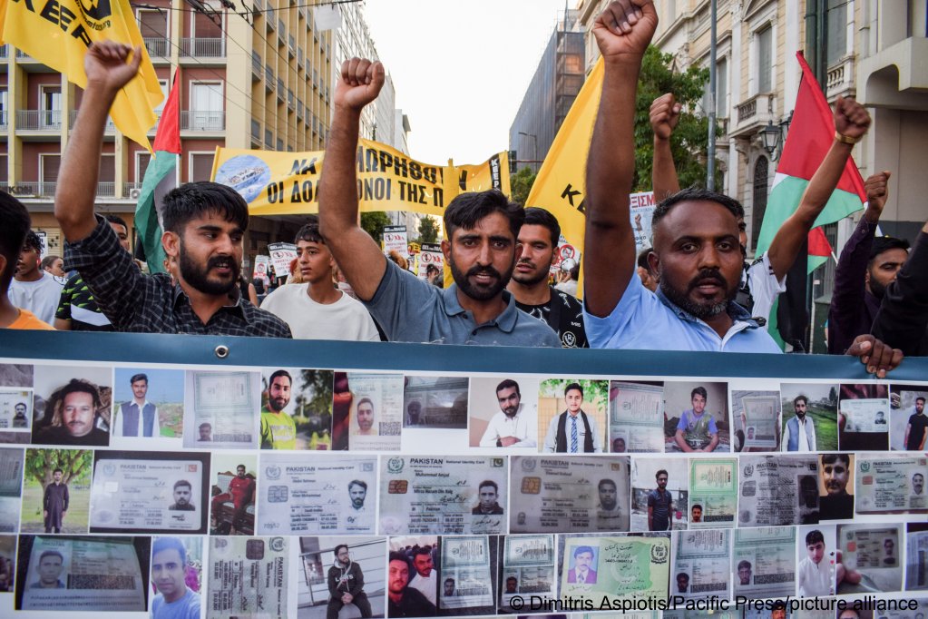 Pakistani survivors shout slogans in June 2023 while holding a banner with pictures of victims during a protest to mark a year after the Pylos tragedy, seen as among the worst migrant boat tragedies | Photo: Dimitris Aspiotis/Pacific Press/picture alliance 