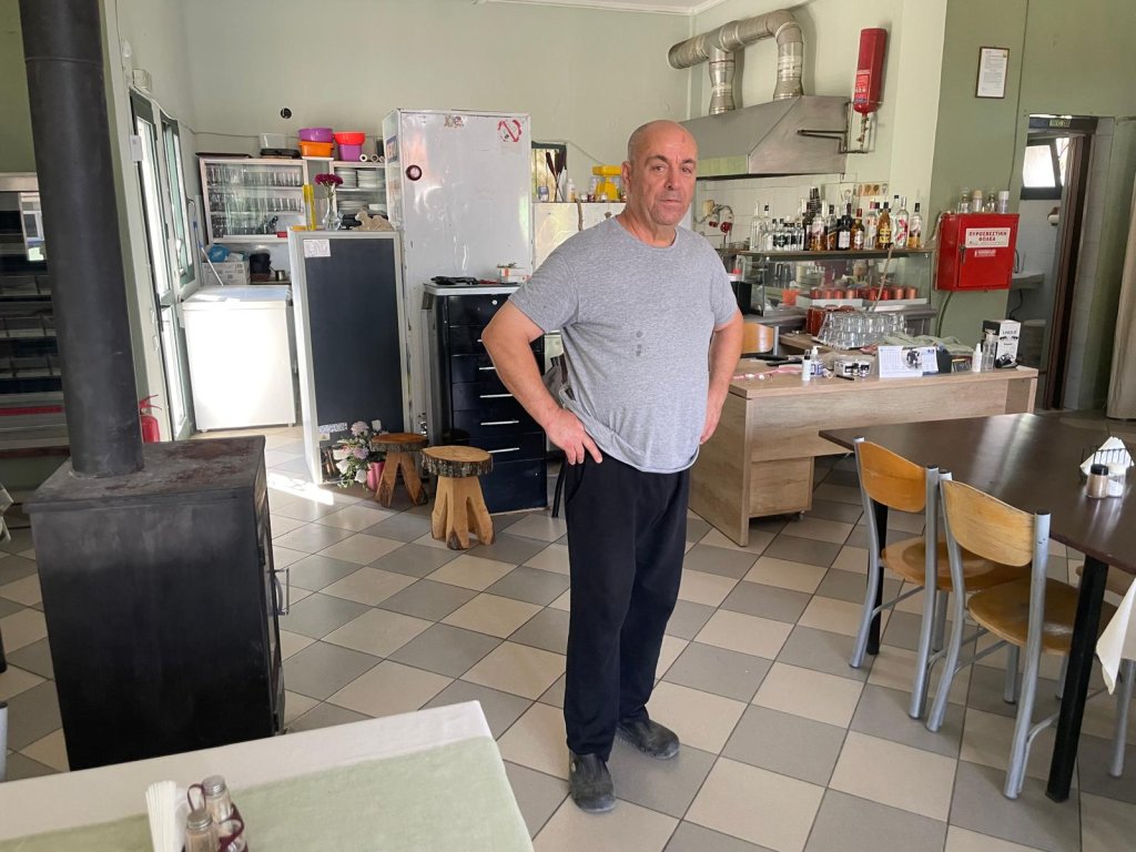 Vagalis, the cafe owner, inside his restaurant-bistro | Photo: InfoMigrants
