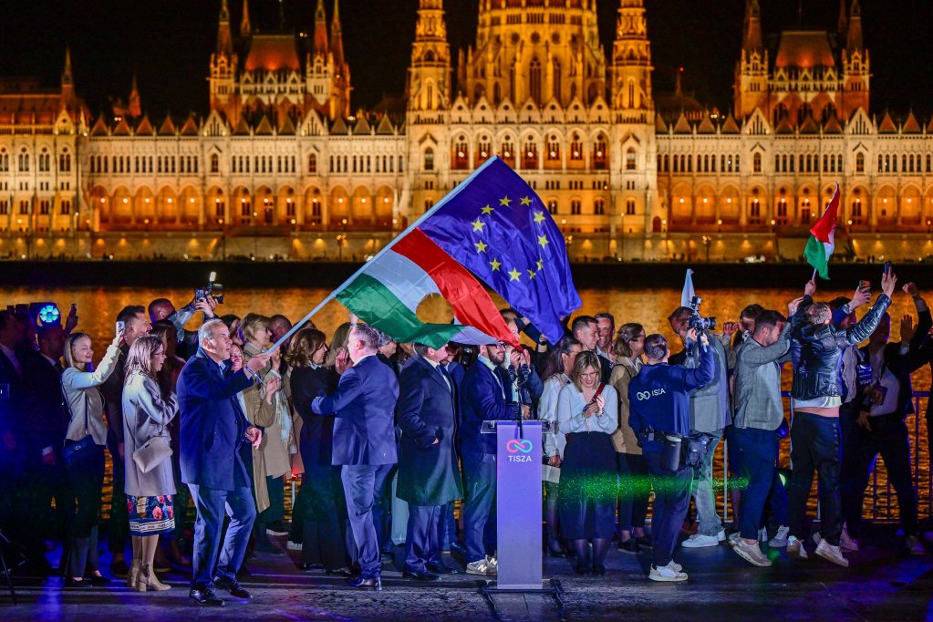 The EU and revolutionary national flags fly in Budapest after a speech by Peter Magyar following the partial results of the parliamentary election in Hungary on April 12 | Photo: Marton Monus/Reuters
