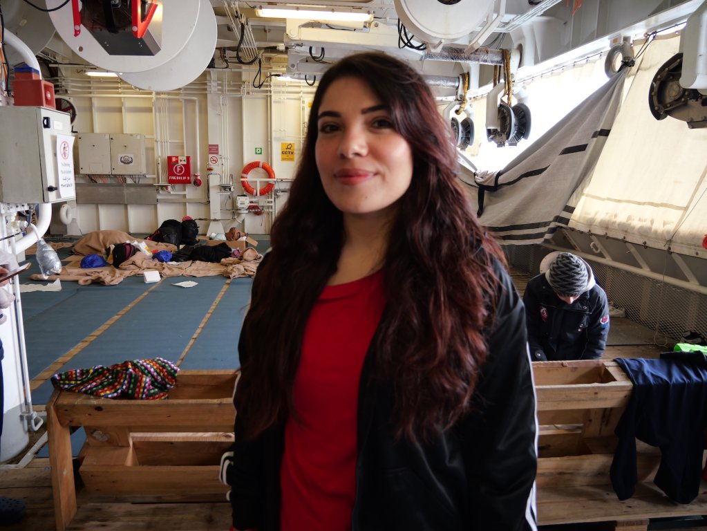 A young woman from Syria smiles for the camera on board the Geo Barents | Central Mediterranean Sea, February, 2024 | Photo: Sou-Jie van Brunnersum