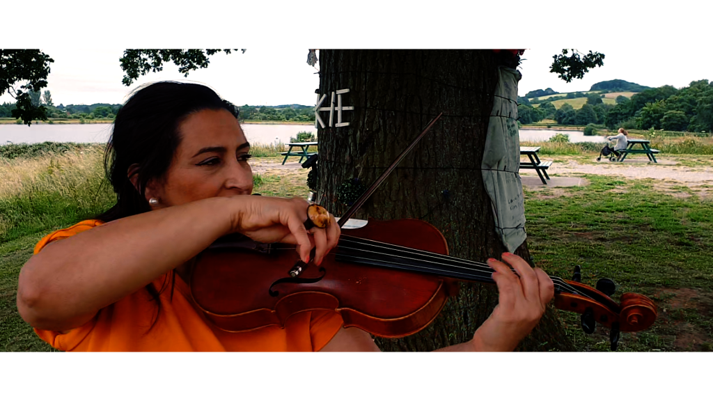 Raghad Haddad playing her viola for the 'Walk with me' video | Photo: Together productions / IOM