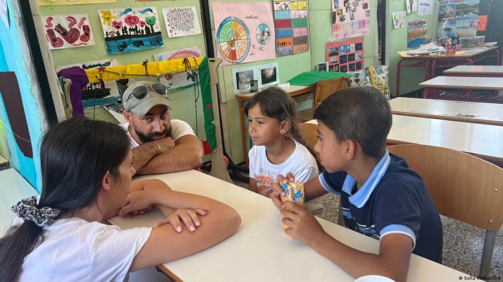 Ayham and Lin with a translator and a member of staff | Photo: Sofia Kleftaki/DW