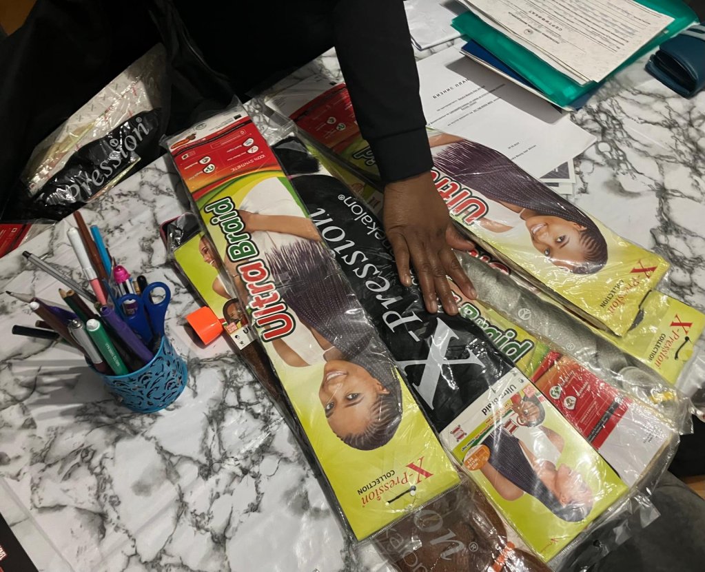 Sandra shows off her hairdressing equipment. She meets clients at home while waiting to open her own salon one day | Photo: InfoMigrants