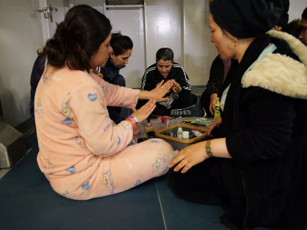 Amina (pictured left) shows her freshly painted nails to her new friend on board the Geo Barents | Central Mediterranean Sea, February, 2024 | Photo: Sou-Jie van Brunnersum