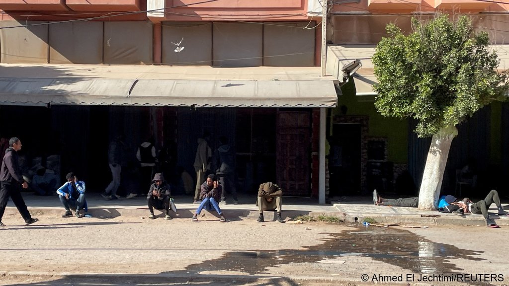 These sub-Saharan farmhand workers in Ait Amir wait to be picked up for a day's labor; many don't have permanent homes and spend most nights sleeping rough | Photo: Ahmed El Jechtimi / REUTERS