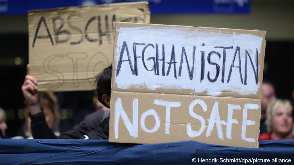 Participants in a vigil are standing in the terminal at Leipzig/Halle Airport, holding up a sign that reads "Afghanistan not safe" on June 15, 2026. They are protesting an alleged deportation flight to Afghanistan | Photo: Hendrik Schmidt/picture-alliance