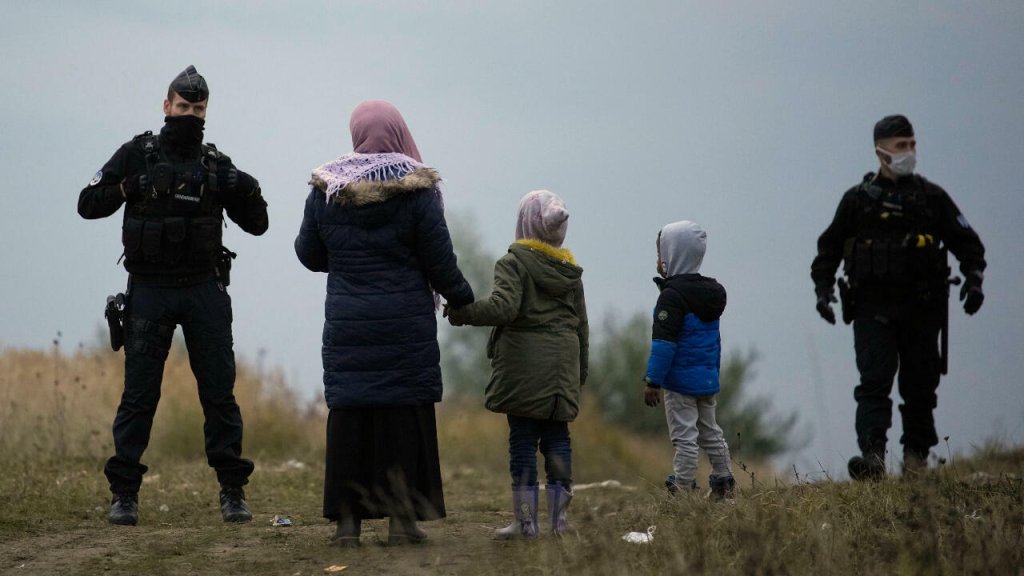 From the point-of-view of many Middle Eastern and African migrants in Calais like this family, race and ethnicity appear to play a role when deciding who might receive dignified treatment | Photo: Christophe Ena, AP