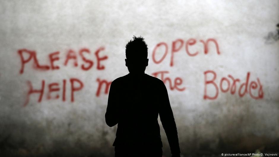 A migrant stands in an abandoned storehouse in Belgrade in 2018 | Photo: Picture-alliance/AP Photo/D.Vojinovic