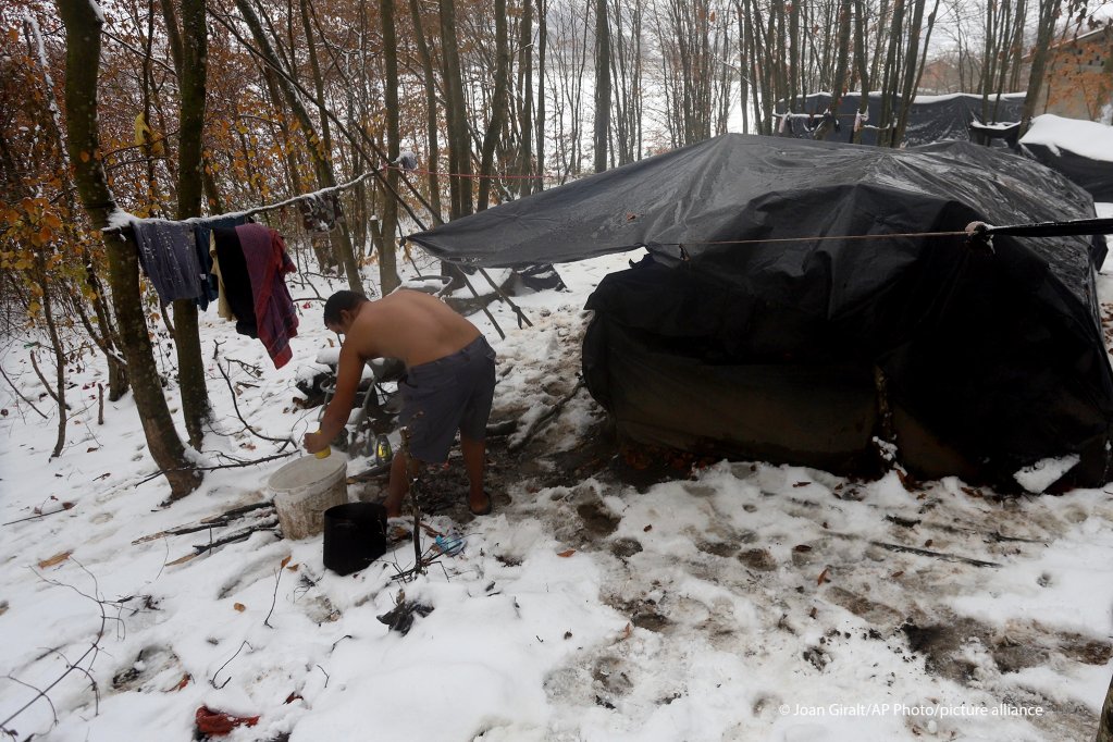 Migrants stand next to improvised tents at a makeshift camp in a forest outside Velika Kladusa, Bosnia, December 3, 2020 | Photo: Joan Giralt / AP Photo / picture-alliance