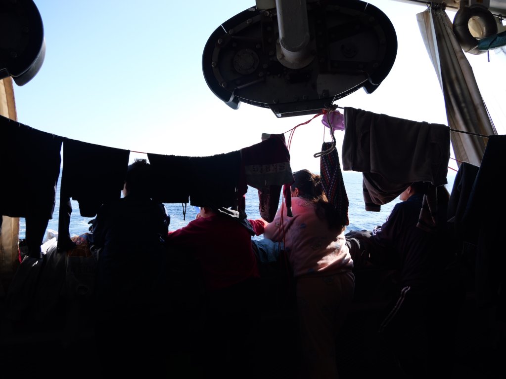 Syrians on board the Geo Barents look out at the vast Mediterranean Sea as the the search and rescue ship makes its way to Ravenna, Italy | February, 2024 | Photo: Sou-Jie van Brunnersum