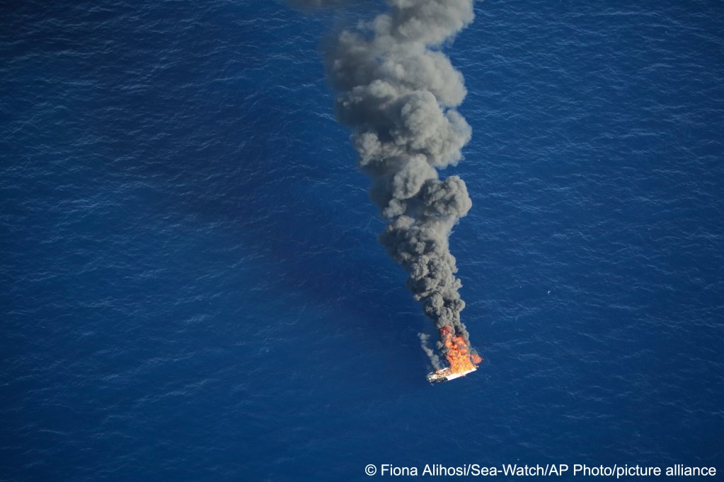 According to Sea-Watch this migrant boat was seen burning after the migrants on board had been intercepted by the Libyan coast guard and taken on board their ship | Photo: Fiona Alihosi/Sea-Watch via AP / picture alliance 