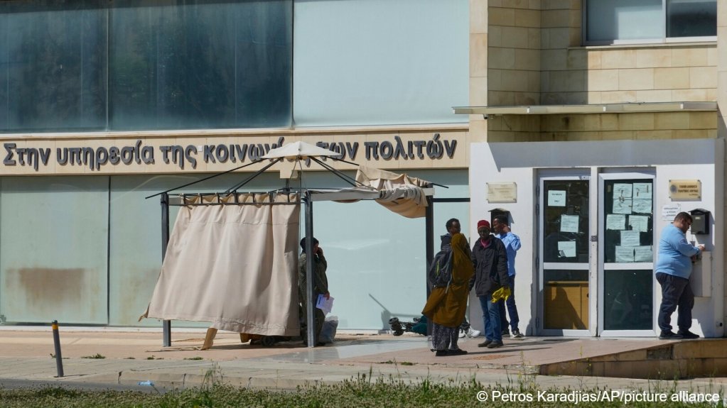 Migrants wait outside an immigration department building in the Lakatamia area of the capital Nicosia, Cyprus, Wednesday, March 12, 2025 | Photo: AP Photo / Petros Karadjias