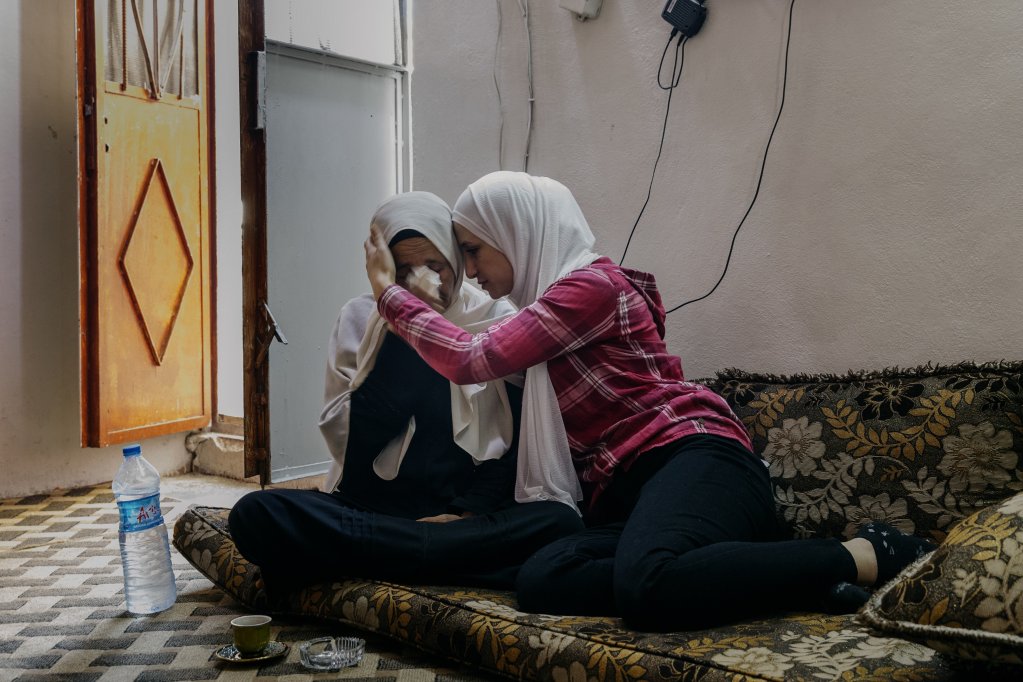 Devastated by her son's disappearance, Aeda has developed health problems. Her daughter, Mohamed's younger sister, tries to comfort her. Damascus, Syria, September 23, 2025 | Photo: Valentina Camu/Divergence