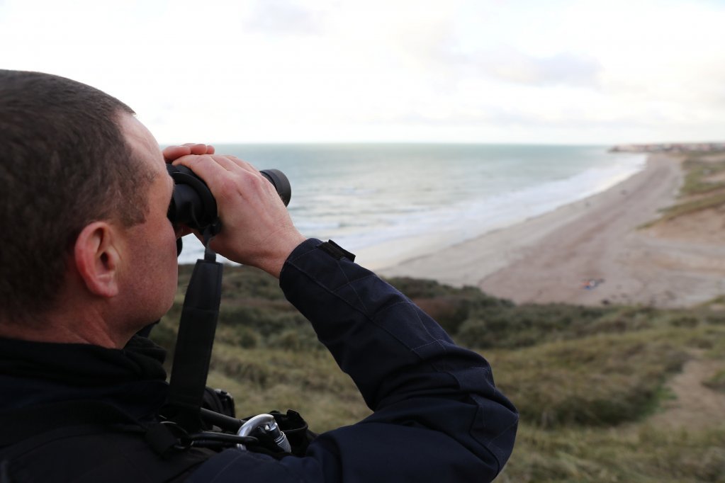 From file: A French police officer surveilles the north coast of France | Photo: Reuters