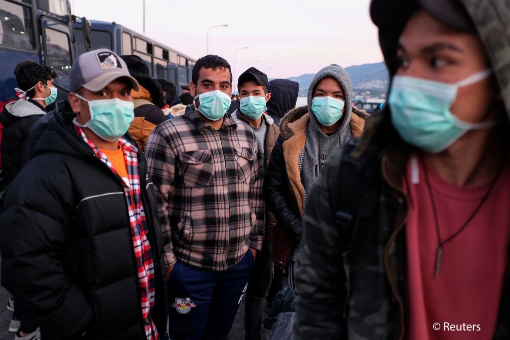 Migrants wearing face masks at the port of Mytilene on Lesbos, Greece in March 2020 to limit the spread of COVID-19 | Photo: Reuters/Elias Marcou