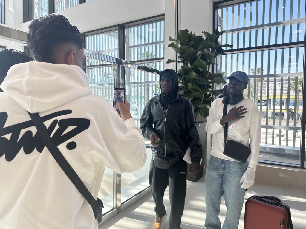 Mahamoud Abdeldin (right) and a friend make a video for social media, March 2026 at the Port of Ceuta | Photo: InfoMigrants