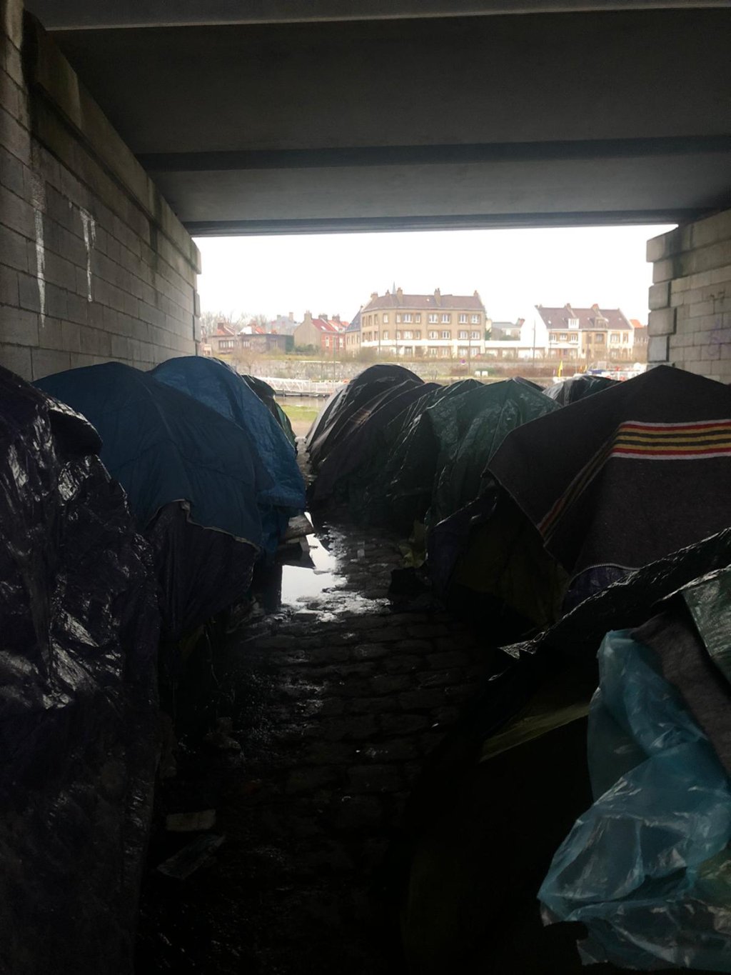Sheltering under a bridge in Calais in winter conditions | Photo copyright: Care4Calais, January 2021