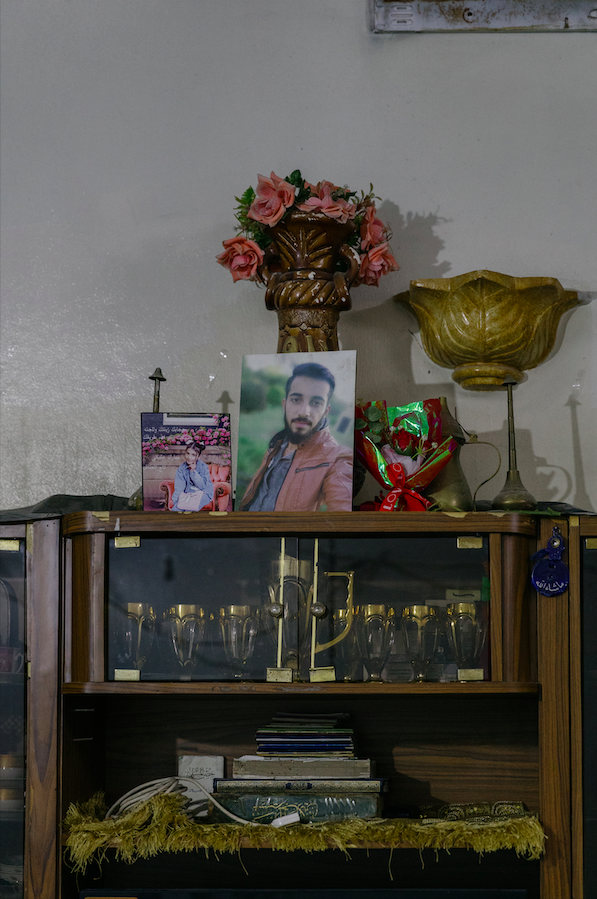 Mustafa’s portrait sits at the top of the only piece of furniture in the room. His mother Amina placed it in the prominent location but usually keeps it somewhere else to avoid the pain that seeing it causes her | Photo: Valentina Camu / InfoMigrants