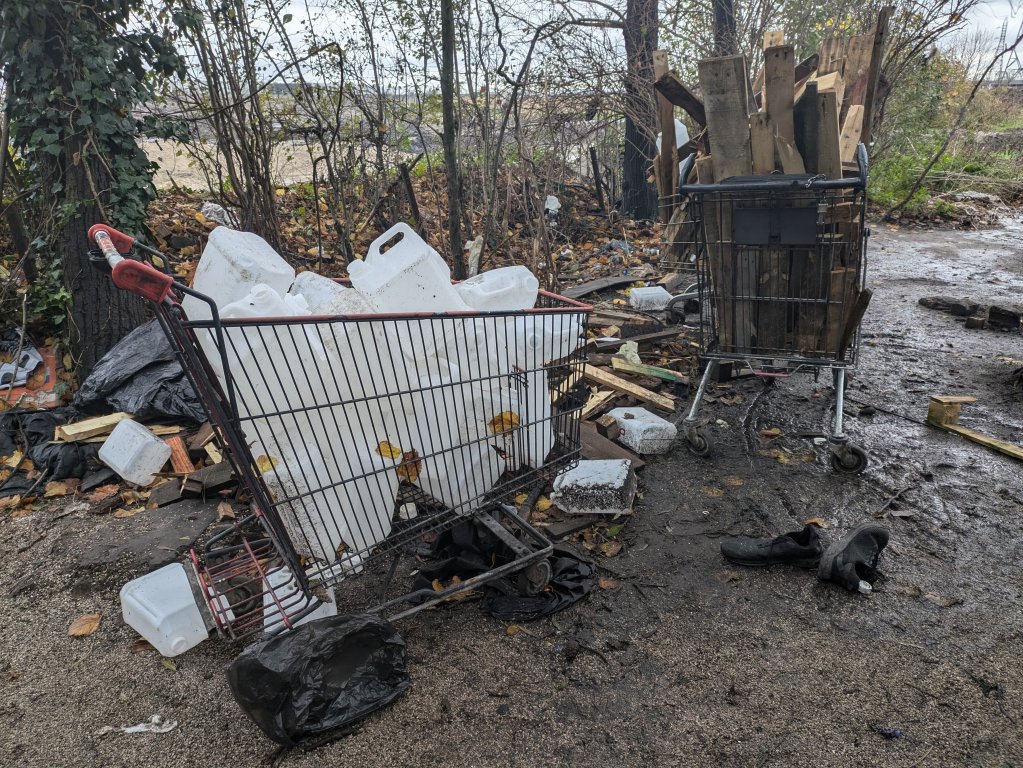 Shopping trolleys filled with water canisters and fire wood in a small migrant camp in Calais | Photo: InfoMigrants