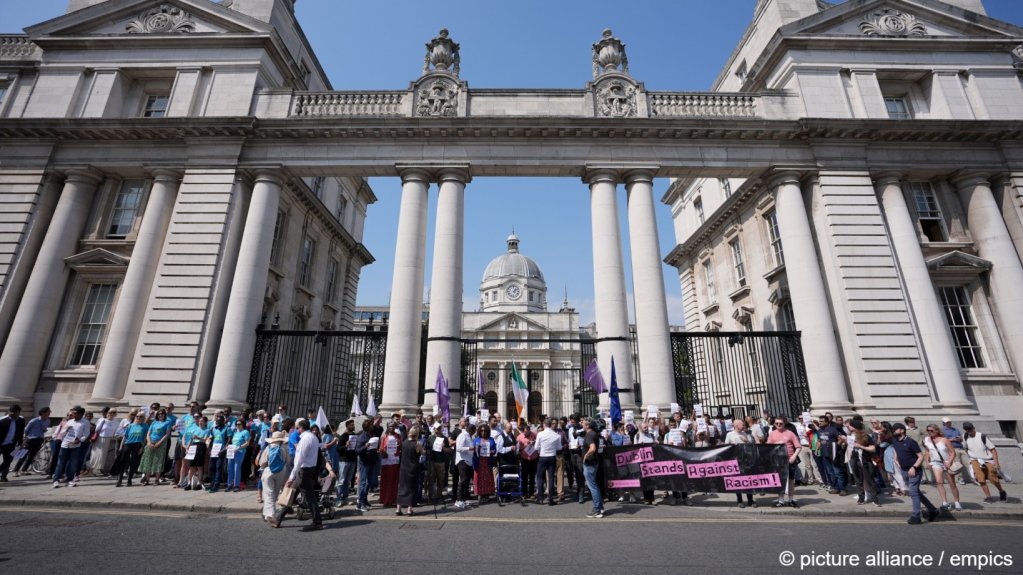 People take part in a silent assembly for migrant workers and their families outside the Department of the Taoiseach in Dublin, following the recent attacks on members of the Indian community | Photo: Niall Carson/PA Wire / empics