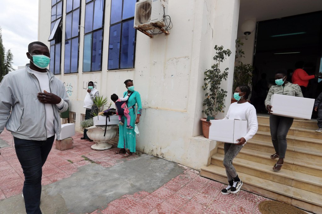 The photo shows African immigrants carrying aid boxes distributed at the Raoued town hall in Tunis, Tunisia, 22 April 2020 | Photo: EPA/MOHAMED MESSARA