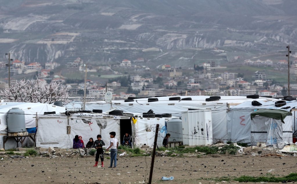 Syrian refugees in front of makeshift tents at Al Faydah refugee camps, near Zahleh in the Bekaa Valley, Lebanon, 12 March 2020 | Photo: EPA/NABIL MOUNZER