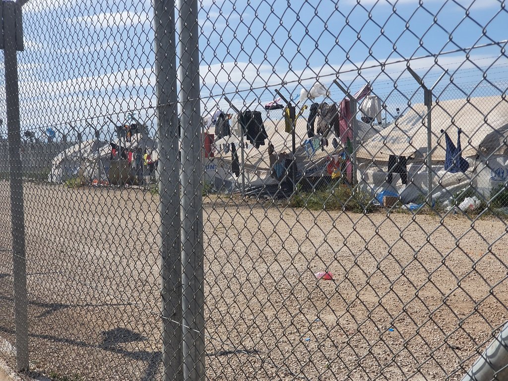 جانب من المخيم حيث تظهر الخيام المقدمة من مفوضية اللاجئين، وحبال الغسيل التي ترافقها في المشهد. مهاجر نيوز