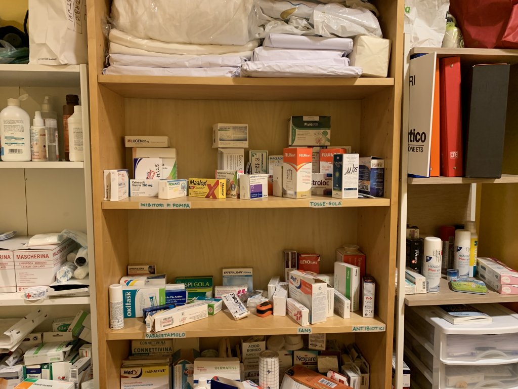 A stock of different medicines fill the shelves at the Donk consultation room at the day center in Via Udine | Photo: Emma Wallis / InfoMigrants