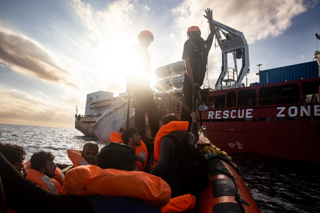The crew of the Ocean Viking help some of the 128 migrants rescued this weekend on board ship in the central Mediterranean | Photo: SOS Mediterranee X page @SOSMedIntl