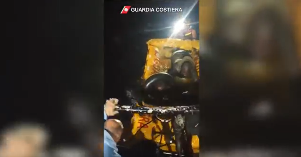 The Italian coast guard couldn't reach th migrants by land, so had to send a small inflatable raft to bring them slowly from the cliffs to their boat | Source: Italian coast guard Guardia Costiera press release