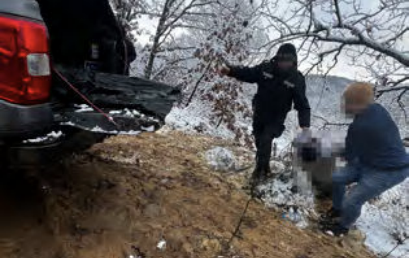 Police officers dragging the frozen body of Ahmed Samra to their vehicle | Screenshot: Frozen Lives Report / No Name Kitchen