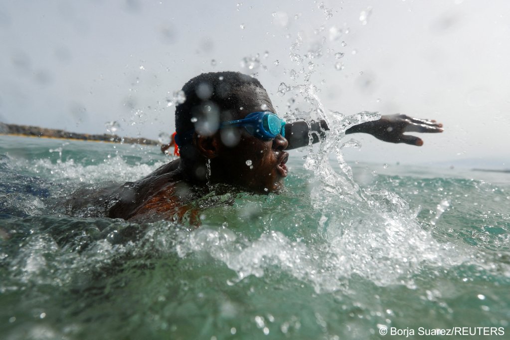 Mamadou M Bathily, a 24-year-old migrant from Mali, takes part in the activity enthusiastically splashing through the water | Photo: Borja Suarez/Reuters