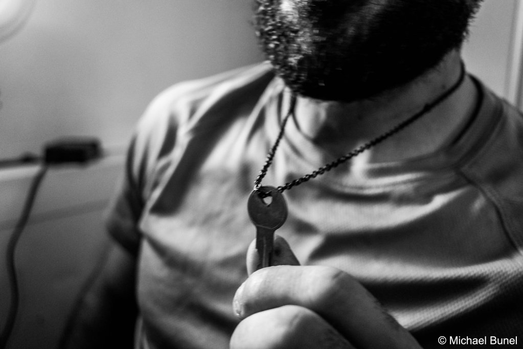 Around his neck, Astoun wears the engine key of the first boat he rescued at sea. January 8, 2023 | Photo: Michael Bunel