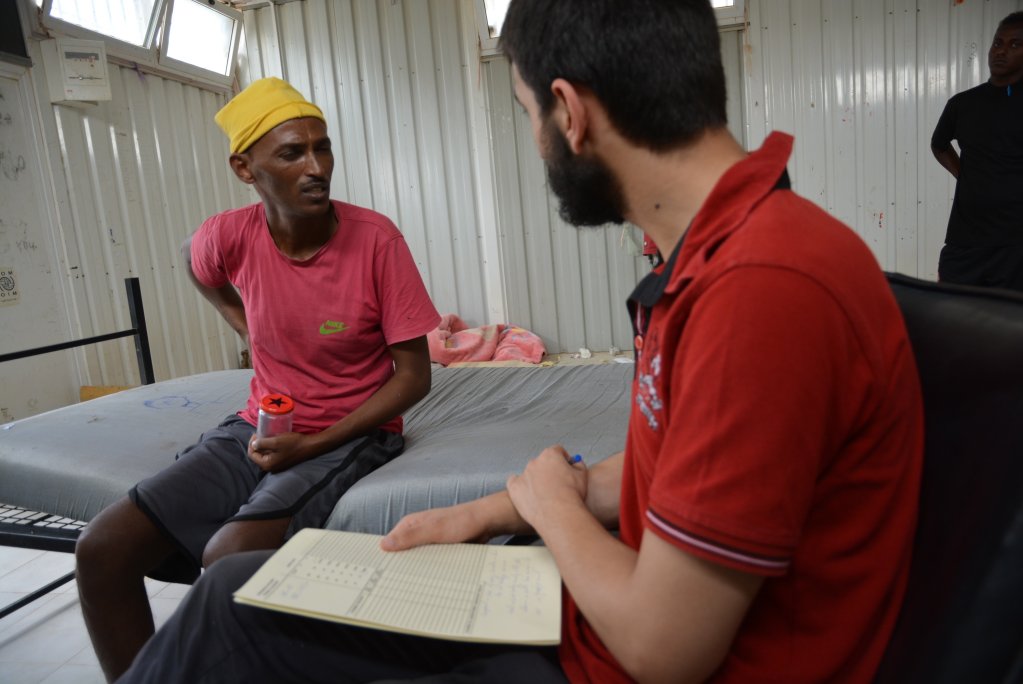 John, a migrant from Eritrea, during a medical consultation with an MSF doctor in Gharyan al-Hamra detention center. He had tuberculosis and was locked in a container for months without access to healthcare, Libya 2019 | Photo: Jérôme Tubiana/MSF