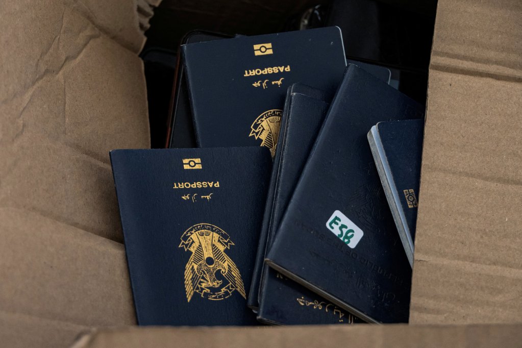 Passport of newly-arrived migrants are placed in a box inside a municipal hall in the town of Agyia, on the island of Crete, Greece, July 13, 2025. REUTERS/Nicolas Economou