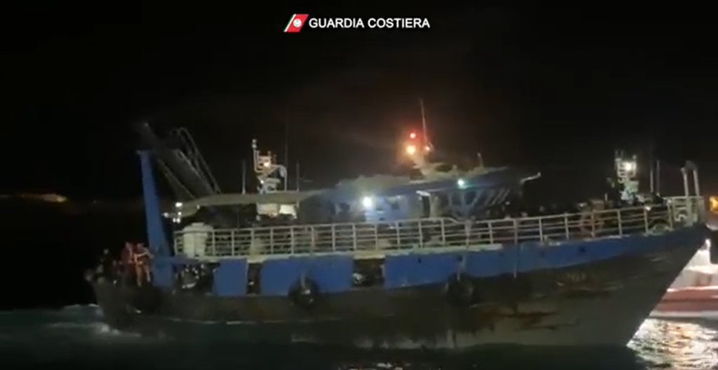 A fishing boat carrying 576 migrants, according to the Italian coast guard, is escorted into Lampedusa's harbor | Source: Italian coast guard Guardia Costiera press release