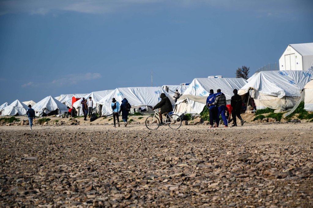 From file: Migrants walking outside their tents at the Karatepe refugee camp on Lesbos island, Greece | Photo: ARCHIVE/ EPA/VANGELIS PAPANTONIS