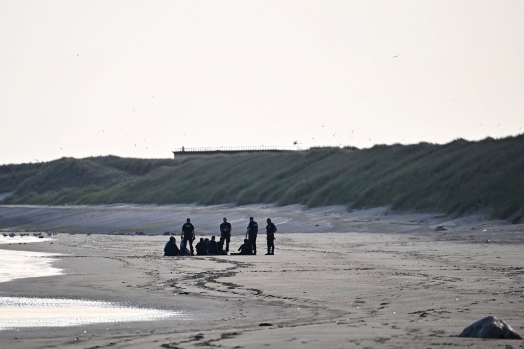 Police talk to a group of migrants who tried to board a crowded inflatable dinghy and leave the coast of northern France in an attempt to cross the English Channel to reach Britain, on the beach of Petit-Fort-Philippe in Gravelines, near Calais, France, May 23, 2026. REUTERS/Dylan Martinez