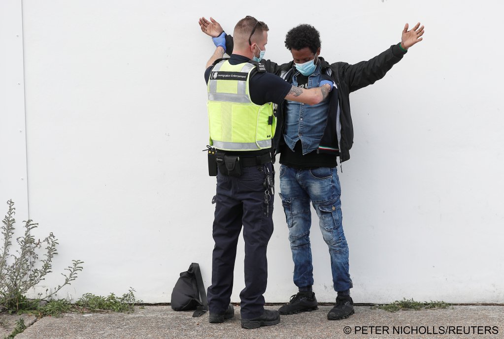 A migrant is checked by a Border Force officer after being rescued in the English Chanel | Photo: Peter Nicholls / REUTERS