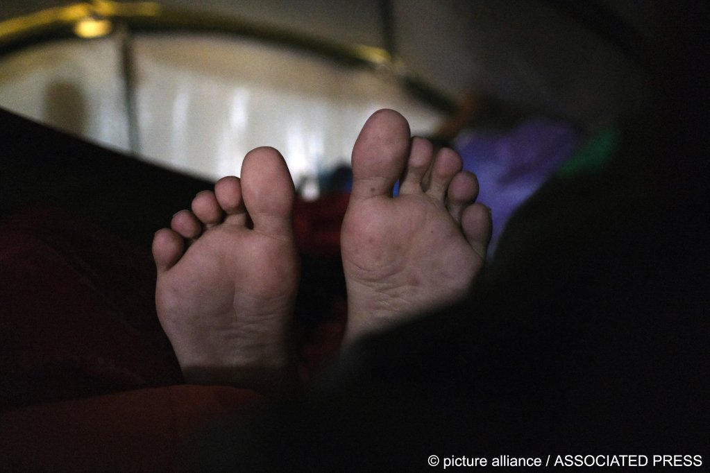 From file: A migrant rests in a camp in Bosnia part way along the Balkan route. The cold can cause people to lose digits or even limbs if exposed for too long | Photo: Kemal Softic / picture alliance / Associated Press
