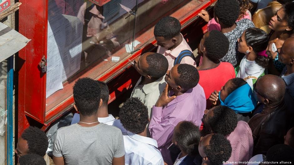 Young Ethiopians are scanning job offers posted in a display case in Addis Ababa | Photo: Thomas Imo/photothek.net/picture-alliance