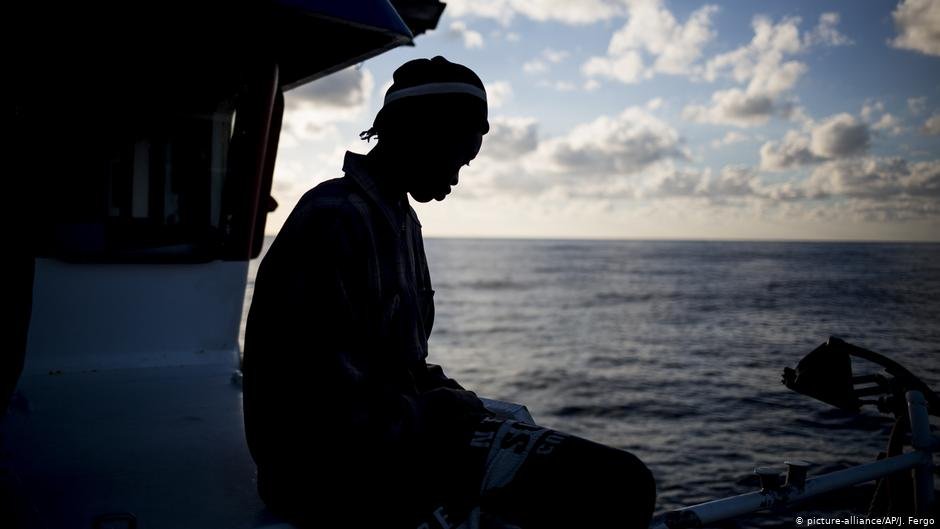 A Senegalese man sits on the deck of a Spanish fishing boat | Photo: picture alliance/J. Fergo