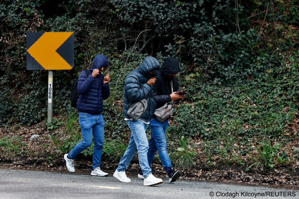 Asylum seekers walk on a country road near the Crooksling tented accommodation site near Dublin on May 1, many later left the site saying it was flooded and too isolated | Photo: Clodagh Kilcoyne / Reuters